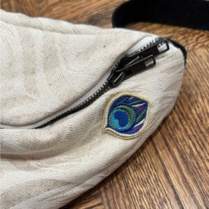 Chic Cream Crossbody Bag with Peacock Detail